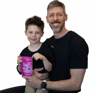 jordan smith holding child who is holding the blossom gum bag