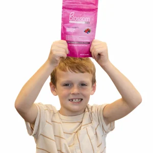 child holding blossom gum bag